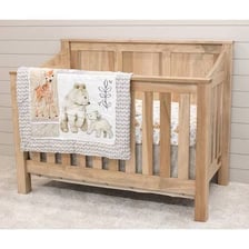A baby crib positioned in a nursery.