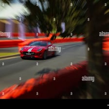 A Jaguar automobile driving along a road.