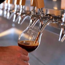 A glass being filled from a beer tap.
