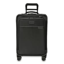 A traveler beginning a journey with a rolling suitcase.