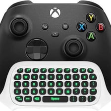 A gaming chat interface beside a keyboard, illustrating online jargon