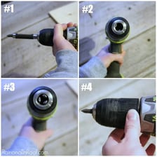 A metal drill bit mounted in the chuck of a power drill.