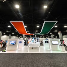 A busy trade show floor with exhibition booths.