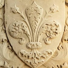A stylized fleur-de-lis emblem.