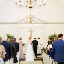 People participating in a formal religious ceremony