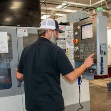 A person operating machinery from a control panel