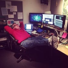 A film editor reviewing movie footage on a screen.