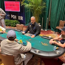 Poker chips being placed into the pot as an ante