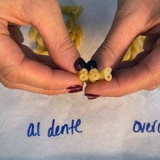 A fork holding pasta cooked al dente