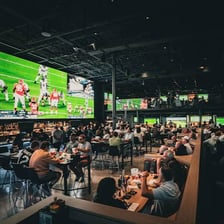 Several televisions showing sports in a sports bar