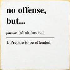 A humorous button marked “No offense”