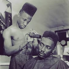 A hi-top fade haircut with a tall top and closely shaved sides