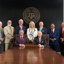 Members of a university governing board seated at a meeting.