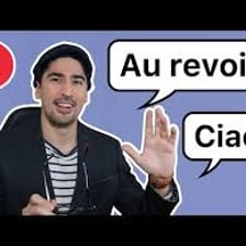 A person waving goodbye in a French-language setting