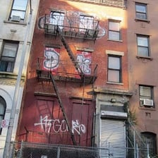 An unattractive building standing out among neighborhood homes.