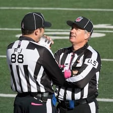 A football referee officiating on a field