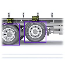 A vehicle at a tollbooth with its axles being counted