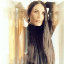Demi Moore in a promotional image associated with Ghost and The Substance.