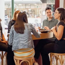 A small group of people meeting informally at a café