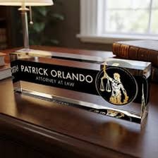 A lawyer’s nameplate displaying a professional title.