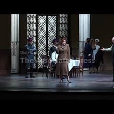 An opera singer performing onstage in an aria.
