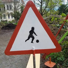 A person looking at and noticing a road sign