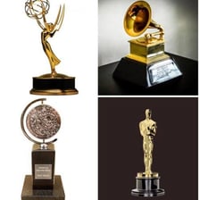The four major entertainment awards represented by an Emmy, Grammy, Oscar, and Tony