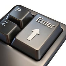 A computer keyboard with the Enter key visible.