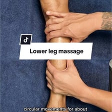 A runner tending to a sore leg after a race.