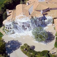 A house decorated with toilet paper after a prank