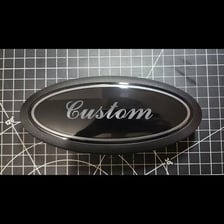 A car emblem displayed in an oval-shaped badge