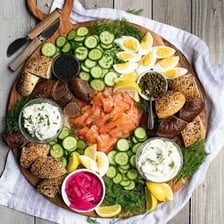 Slices of lox, or smoked salmon, arranged on a serving board.