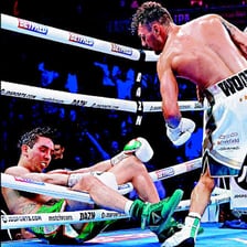 A boxer knocked down in a boxing ring.