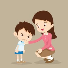 A child reporting another child’s behavior to a teacher