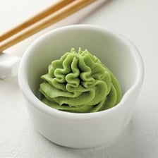 A mound of green wasabi paste in a dish