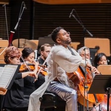 An orchestra performing a modern composition.