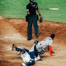 A baseball umpire signaling that a runner is safe