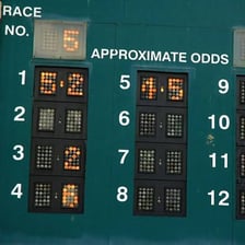 A horse-racing odds board displays betting information.