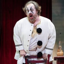 A performer dressed as Tonio, the clown in Pagliacci.