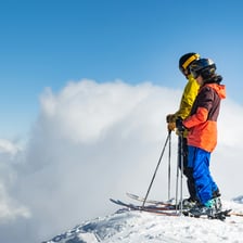 Skier descending a snowy mountain slope