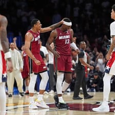 Miami Heat basketball players on a court, including Bam Adebayo.