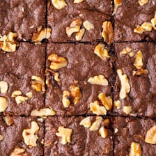 Chocolate brownies containing visible walnut pieces