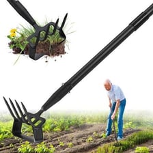 A garden hoe resting in cultivated soil