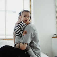 An adult comforting a distressed child.