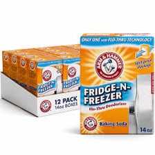 An open box of baking soda placed in a refrigerator to absorb odors