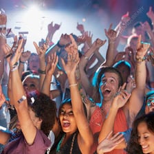 An enthusiastic crowd cheering at an event