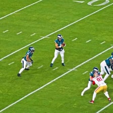 An American football player celebrating after scoring a touchdown