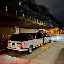 A stretch limousine traveling on a road
