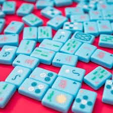 Small colorful game tiles arranged on a table.