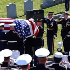A person showing respect at a memorial.